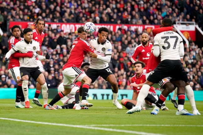 Manchester United's goalkeeper Karl Darlow, center left, and Bournemouth's Tyler Adams challenge for the ball during the English Premier League soccer match between Manchester United and Bournemouth in Manchester, England, Sunday, Oct. 25, 2026. (AP Photo/Dave Thompson)