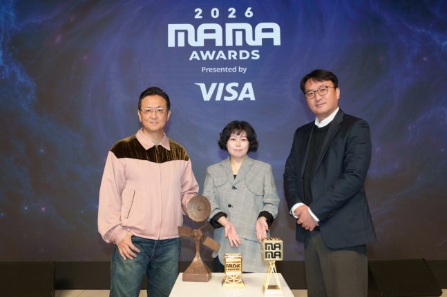 2026 MAMA AWARDSのロゴを背に、メディアデーで並ぶ主催者側の3人。