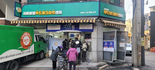 경기 광명시‘광명푸드뱅크마켓센터’앞에 이용자들이 줄지어 선 모습.이현정 기자