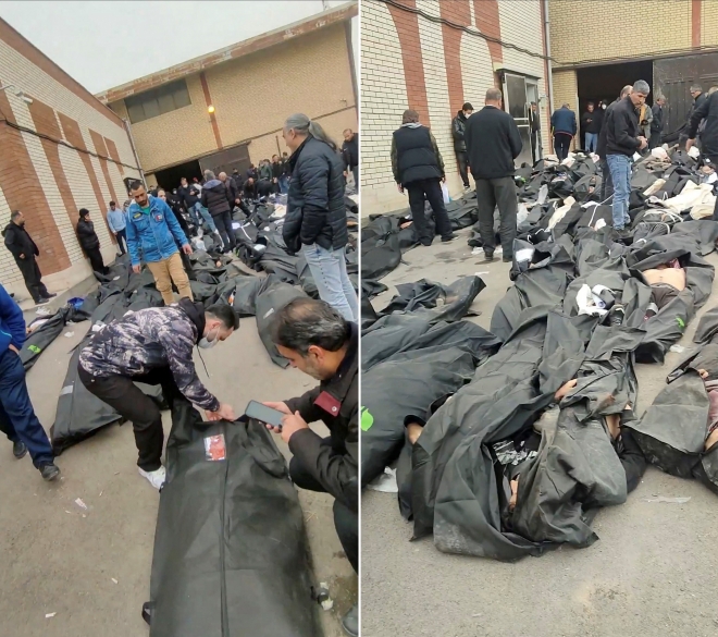 이란 테헤란의 카흐리작 법의학센터 외부에 시신이 담긴 시신 주머니들이 놓여 있다.현장에는 시민들이 모여 상황을 지켜보고 있다.이 영상은 11일(현지시간) 소셜미디어에 유포된 영상을 캡처한 것으로,로이터통신이 건