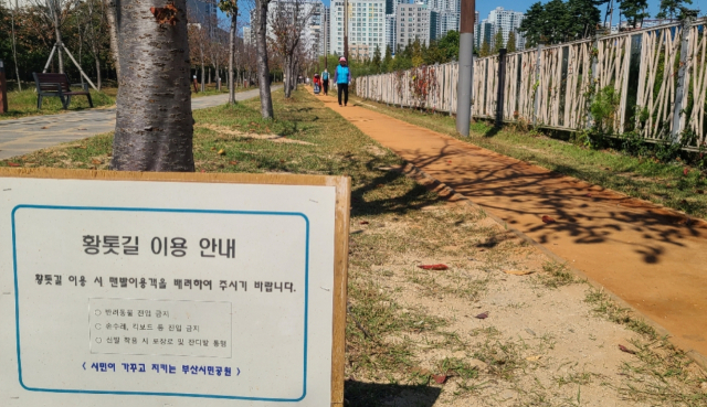 부산시민공원 남1문 경비초소 왼쪽에서 시작해 북1문까지 이어지는 황톳길. 부산시민공원은 맨발 걷기의 신생 명소다.