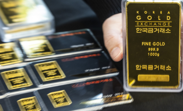 금값이 연일 고공행진을 이어가고 있지만 안잔자산 선호 현상이 뚜렷해지며 투자자들의 관심이 여전히 높다.서울 종로구 한국금거래소 종로 본점 직원이 진열된 골드바를 정리하고 있다.연합뉴스