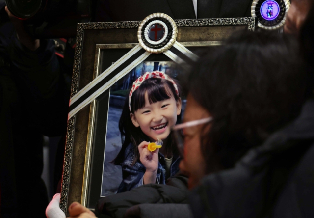 ◇학교에서 교사에게 살해된 8살 김하늘 양.유가족들이 영정사진을 든 채 빈소를 나서고 있다 [연합뉴스]