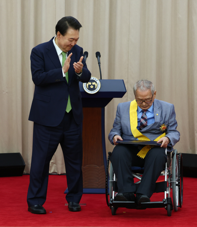 President Yoon Suk-yeol applauding after awarding the National Order of the Mugunghwa Medal to member Lee Sang-man in the field of basic nature at the 70th anniversary celebration of the opening of the Korean Academy of Science at the National Academy of Sciences in Seoul Seocho-gu on the 22nd. Yonhap News