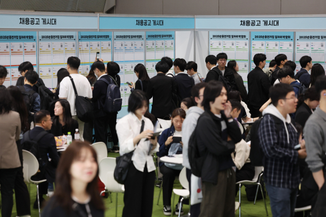 지난달 21일 서울 강남구 코엑스에서 열린 2025 중견기업 일자리 박람회를 찾은 구직자들이 채용공고 게시물을 보고 있다.연합뉴스