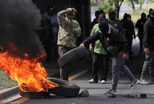 15일(현지시간) 온두라스 수도 테구시갈파에서 대선 투표일 이후 보름이 지나도록 개표가 마무리되지 않자 집권 여당 지지자들이 선거 부정 의혹을 제기하며 시위에 나선 모습.로이터 연합뉴스