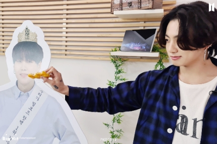 Captured photo of BTS Jungkook as he reached the food to Suga's panel.