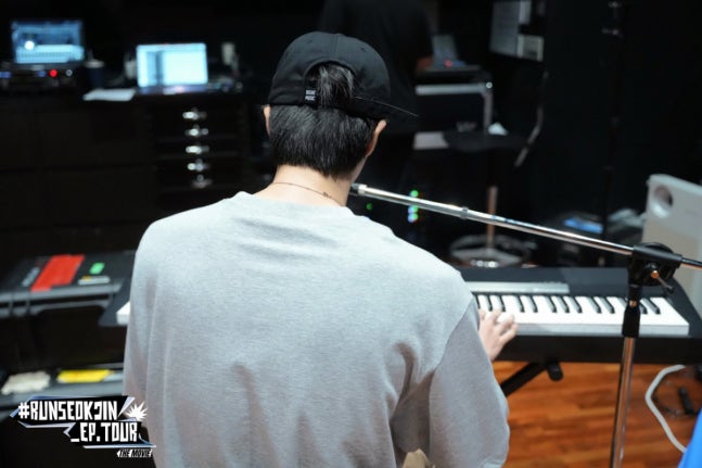 Jin displaying keyboard skills and performance artistry