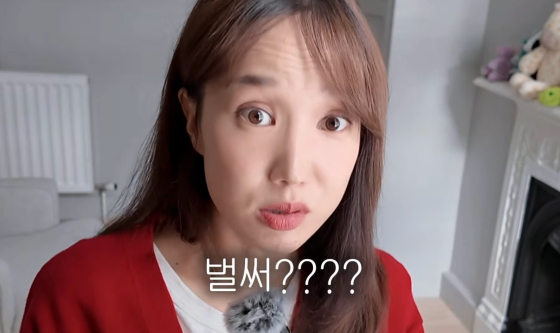 赤いカーディガン姿でカメラを見るクッカビ。YouTube動画の画面に「もう?」の字幕が重なる