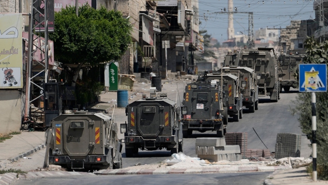 Israeli military vehicles in operation on the west bank of the Jordan River [Photo provided by Yonhap News]
