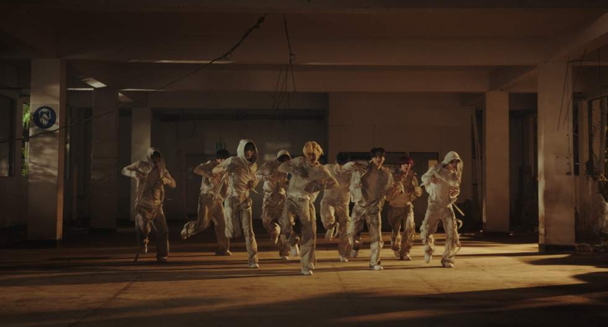 薄暗い廃ビルの中で白い衣装をまとい、踊るCRAVITYのメンバー