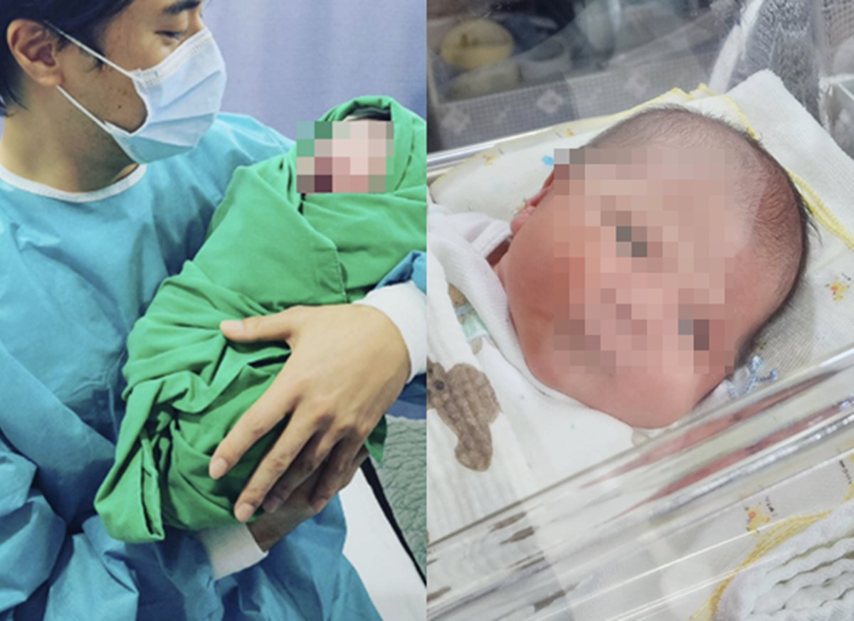 次男を抱くユン・ジュマンと赤ちゃんの写真。赤ちゃんの顔にはぼかしが入っている