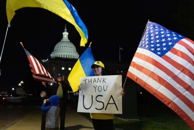 미국 연방 상원이 우크라이나, 이스라엘, 대만에 대한 953억 달러(약 130조5896억 원) 규모의 지원 법안을 통과시킨 23일(현지 시각) 워싱턴DC 국회의사당에서 우크라이나 지지자들이 깃발을 들고 환영했다. /