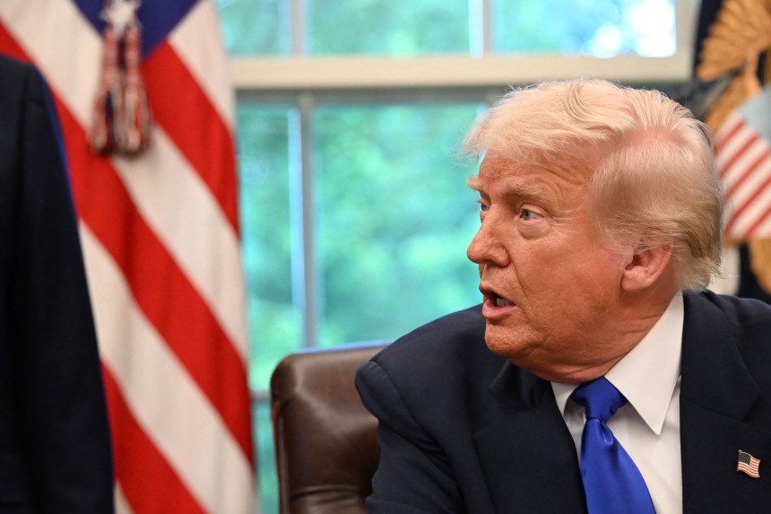  US President Donald Trump speaks to the media while signing executive orders in the Oval Office of the White House, in 