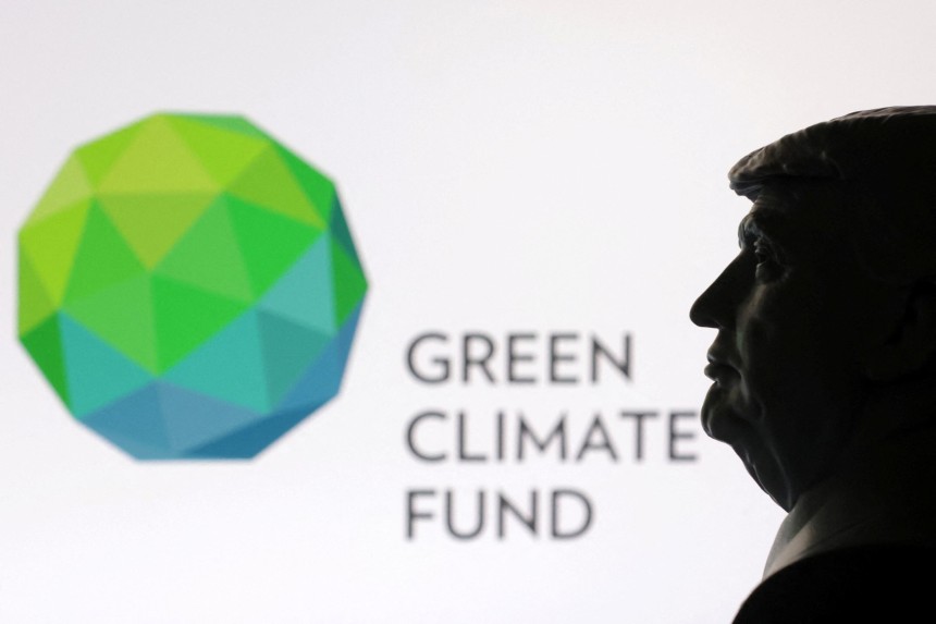  A 3D-printed miniature model of U.S. President Donald Trump with the Green Climate Fund logo in the background is seen 