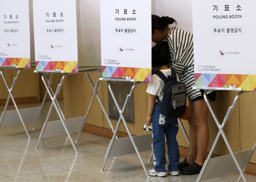 제21대 대통령선거 사전투표 둘째 날인 30일 오전 부산 남구청 대강당에 마련된 사전투표소에서 유권자가 아이와 함께 투표하고 있다.  /뉴스1