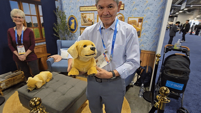 톰봇 관계자가 세계 최대 IT 전시회‘CES 2026’에서 선보인 리트리버를 닮은 강아지 로봇‘제니’를 들어보이고 있다./라스베이거스=정두용 기자