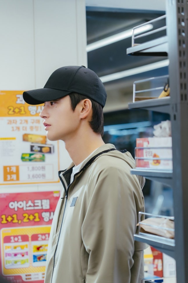 Seo In-guk in casual sportswear and black ball cap in See You At Work Tomorrow drama still