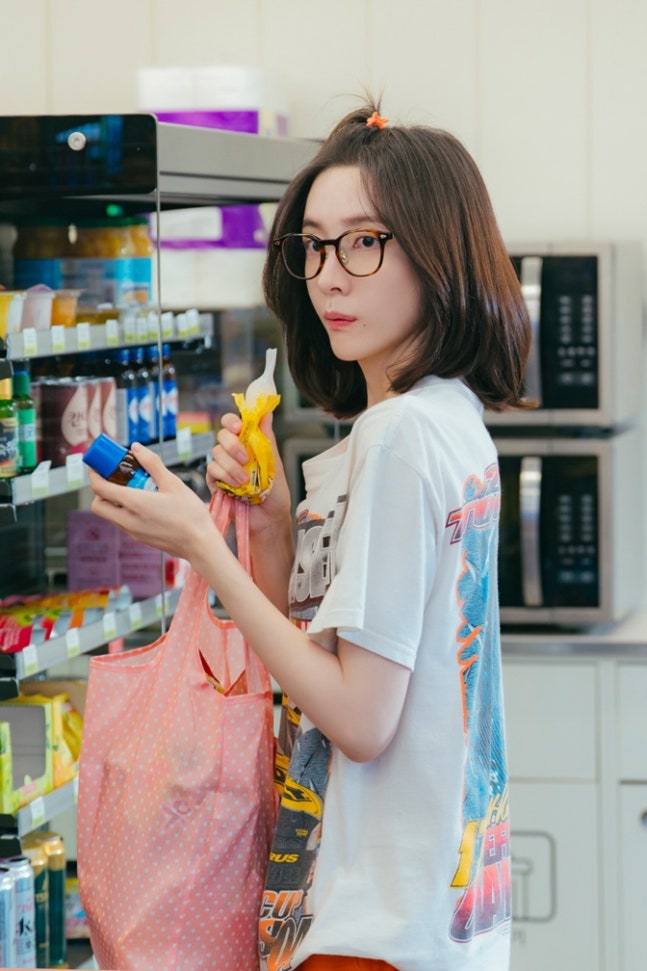 Park Ji-hyun with apple hair and glasses in See You At Work Tomorrow convenience store scene