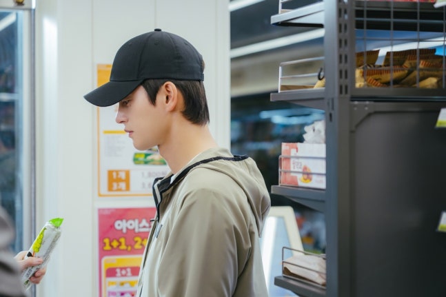 Seo In-guk in casual sportswear and black ball cap in See You At Work Tomorrow drama still