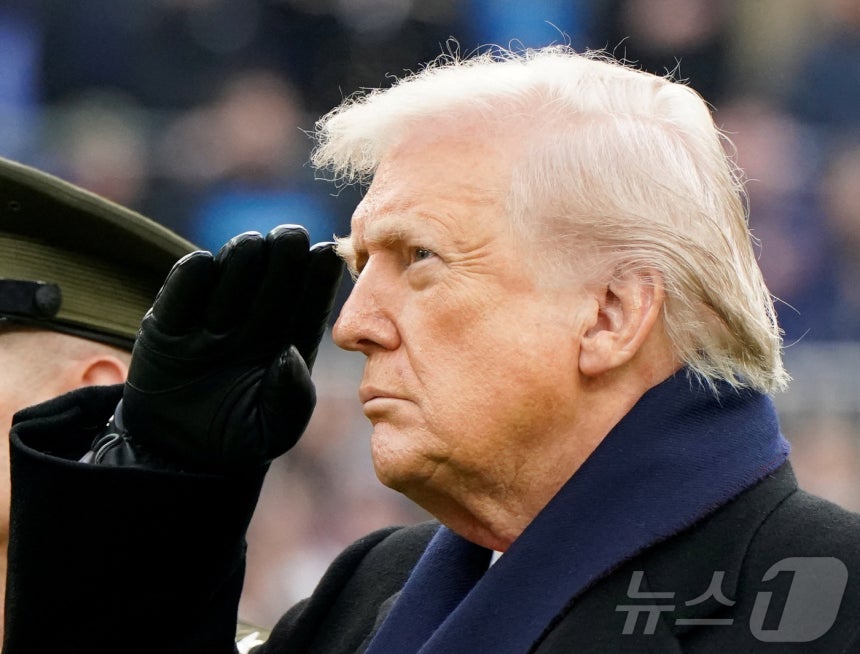 도널드 트럼프 미국 대통령이 13일(현지시간) 메릴랜드주 볼티모어 M&T 뱅크 스타디움에서 열린 육군 대 해군 풋볼 경기에 앞서 미국 국가가 연주되는 동안 거수경례를 하고 있다.트럼프 대통령은 이날 경기 참관을 위