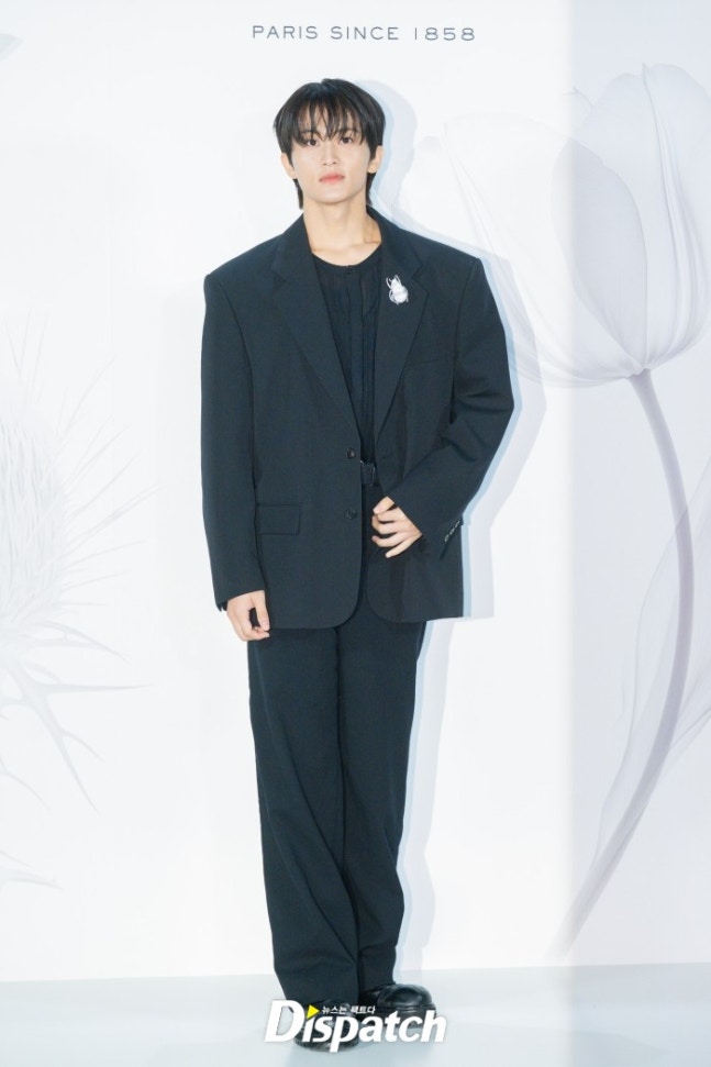 Mark stylishly styled in an all-black suit