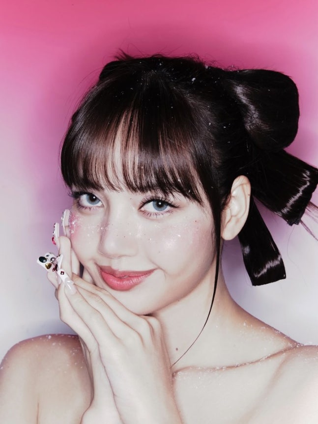 Full body shot of Lisa in holiday corset outfit with falling snow backdrop