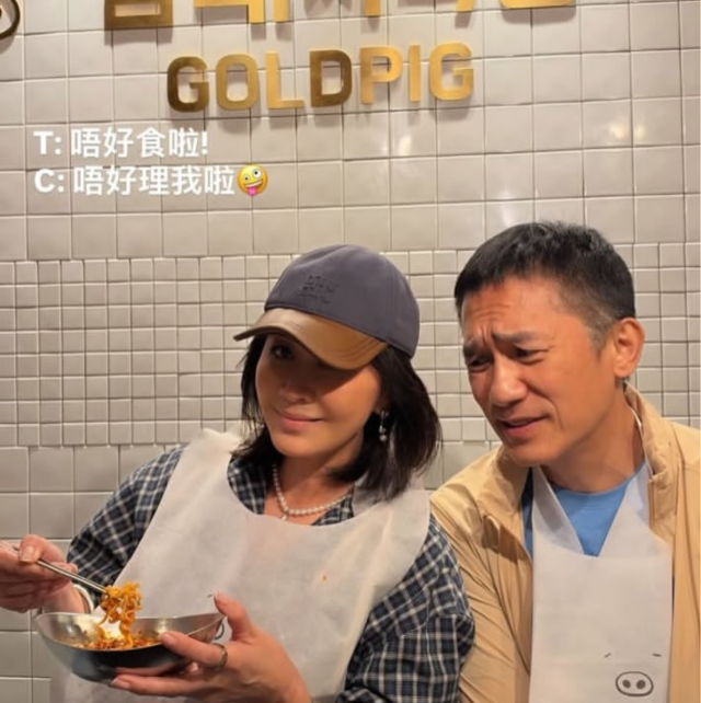 金豚食堂の店内でエプロンを着け、料理を手にする劉嘉玲と梁朝偉
