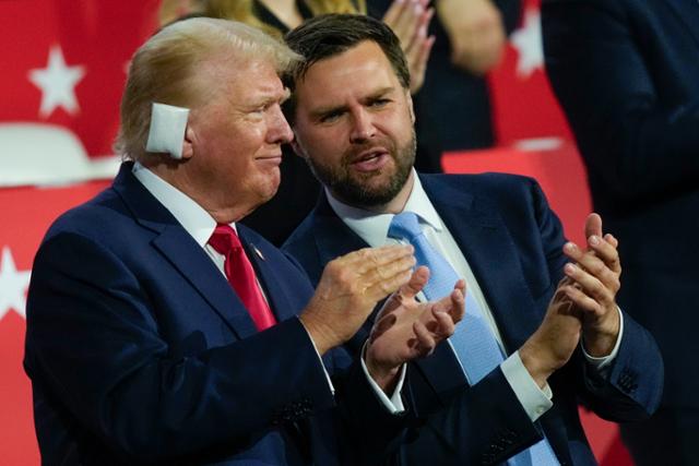 U.S. Republican presidential candidate Donald Trump (left) with a bandage on his right ear where he was shot, attends the Republican National Convention (RNC) which kicked off at Pfister Forum in Milwaukee, Wisconsin on the 15th as he was named as a vice presidential candidate