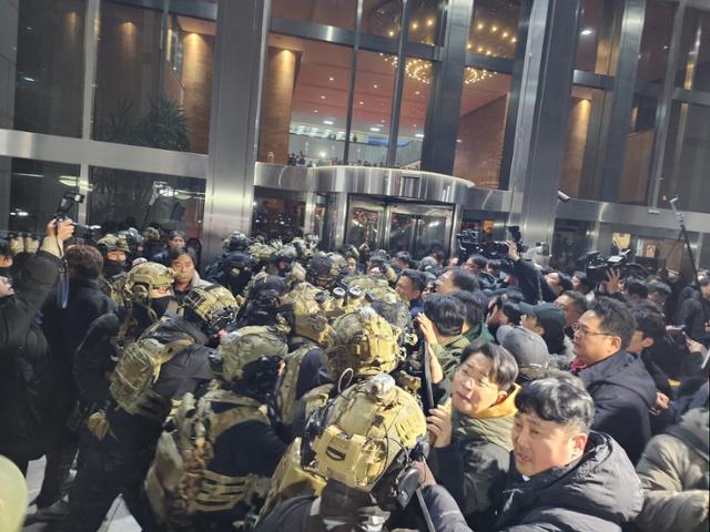 윤석열 전 대통령이 계엄령을 선포한 12월 4일 밤에 계엄군 병력이 국회 본청에 진입을 시도하자 국회 보좌진과 의원들이 막아서고 있다.뉴스1