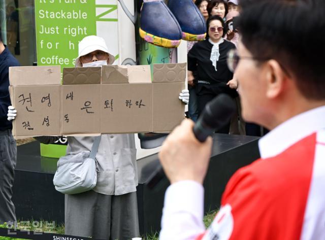 김문수(오른쪽) 국민의힘 대선 후보가 16일 충남 천안시 동남구 신세계백화점 앞에서 유세 발언을 하고 있는 가운데, 한 시민이 '권영세·권성동 은퇴하라'라는 문구를 적은 종이박스를 들어 보이고 있다. 천안=하상윤 기