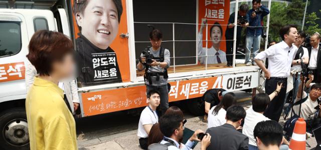이준석(오른쪽 네 번째) 개혁신당 대선 후보가 28일 서울 영등포구 여의도공원에서 유세를 마치고 취재진 질문에 답변하고 있다. 이 자리에서 한 시민은 전날 생방송 대선 후보 TV 토론 중 이 후보가 여성에 대한 성폭