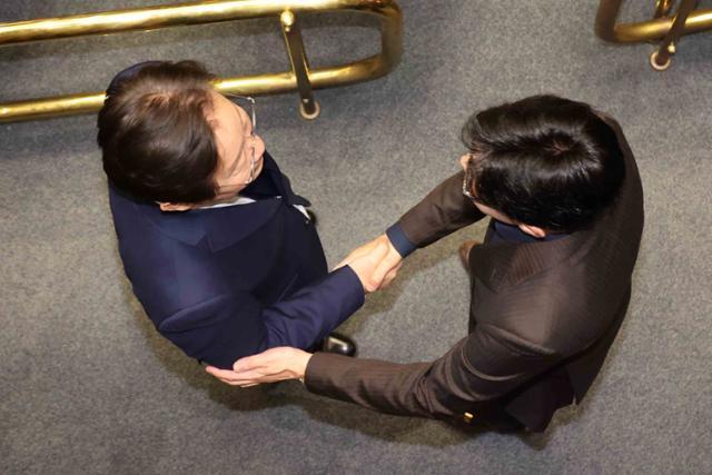 윤석열 전 대통령이 지난해 12월 긴급 대국민 담화를 통해 비상계엄령을 발표할 당시 여의도 국회 본회의장에서 한동훈(오른쪽) 국민의힘 대표와 이재명 더불어민주당 대표가 악수하고 있다. 뉴시스