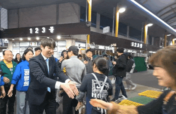 하정우 전 청와대 AI 미래기획수석이 지난 29일 부산 북구 구포시장을 찾아 상인과 악수한 뒤 손을 털고 있다. 온라인 커뮤니티 캡처