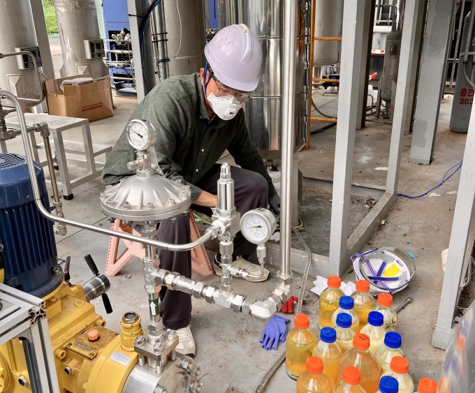 한국화학연구원 연구팀이 대구에 구축한 실증 시설에서 생산한 지속가능 항공유를 용기에 담고 있다.화학연 제공