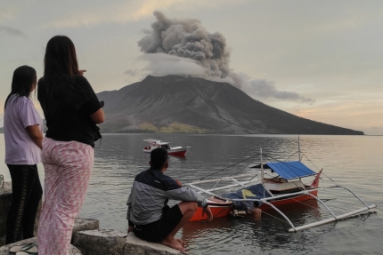 지난 19일 인도네시아 북술라웨시주 타구란당섬 시타로에서 사람들이 바다 건너 루앙 화산의 분화 장면을 지켜보고 있다. ⓒ AFP=연합뉴스