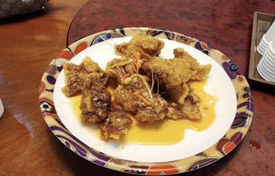 A dish of guobaorou, or Chinese-style sweet and sour pork, with 10 pieces is sold for 22,000 won at a festival in Busan.