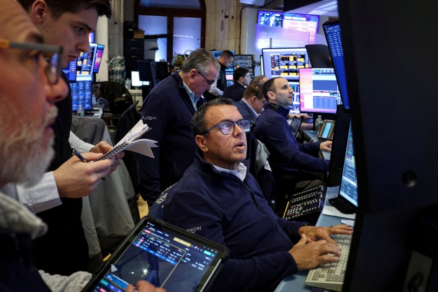 Traders work on the floor at the New York Stock Exchange in New York on March 2. REUTERS/YONHAP