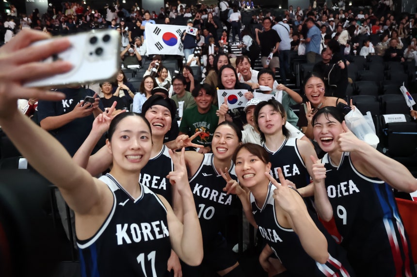 Korea's women's national basketball team players pose for a selfie after beating Japan in the Asian Games women's basket