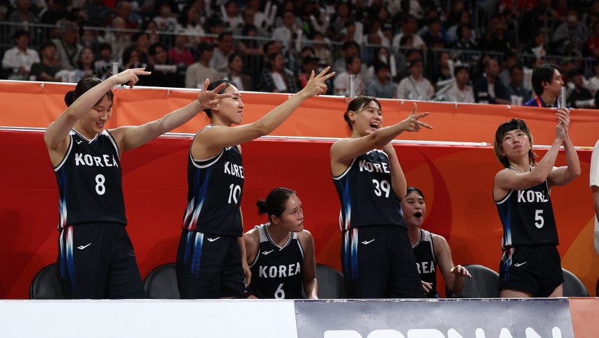 Korea's players cheer after Lee Hae-ran makes a 3-pointer against Japan in the Asian Games women's basketball final at A
