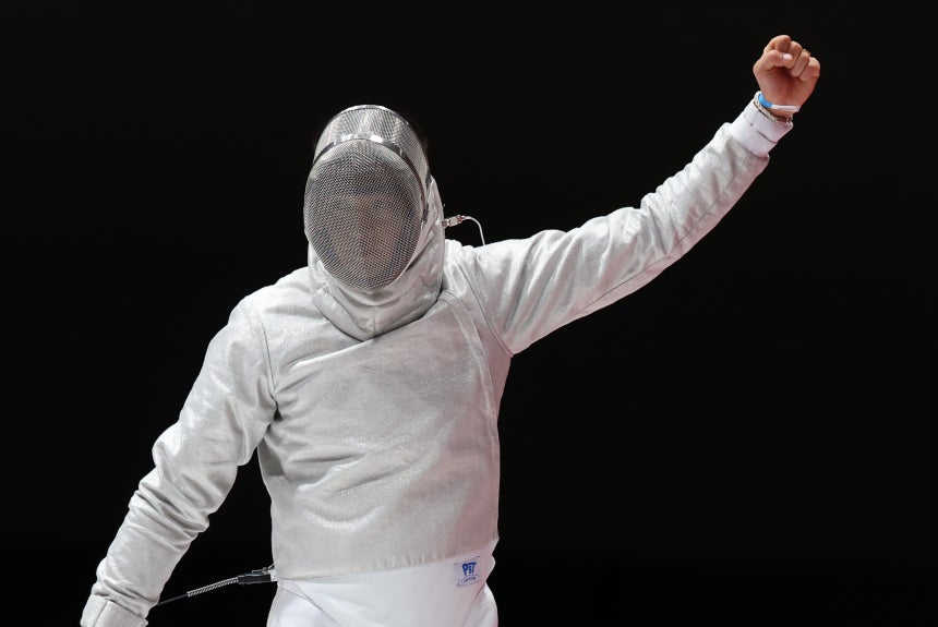 Oh Sang-uk raises his fist as he closes the gap against Japan's Mao Kokubo in the men's team sabre final at the Asian Ga