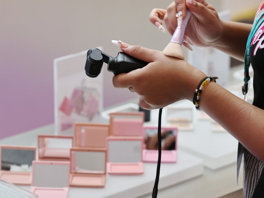 A visitor tests a cosmetics product during the 2025 Seoul Beauty Week at the Dongdaemun Design Plaza in Jung District, c