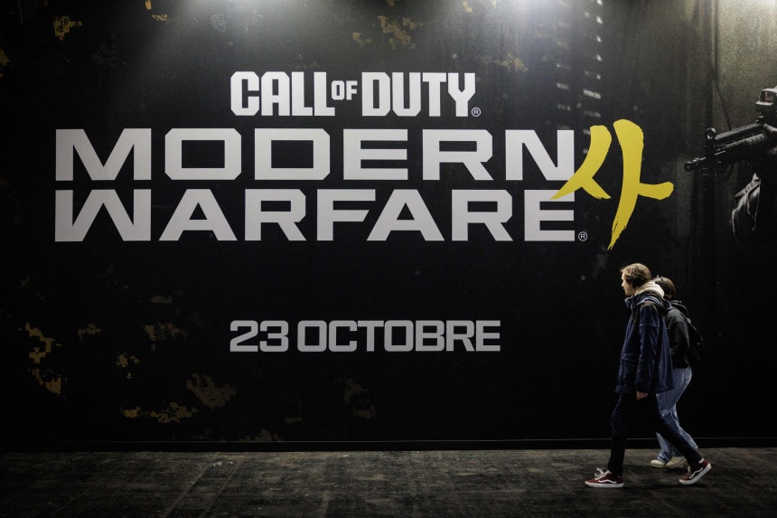 Visitors walk past a Call Of Duty Modern Warfare 4 placard during the preview night of Paris Games Week 2026 in Paris on