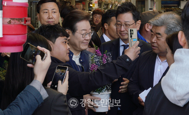 ▲ 더불어민주당 이재명 대선 후보가 2일 철원군 동송전통시장을 방문해 성물받은 화분을 들고 기념촬영을 하고 있다.이재용 기자